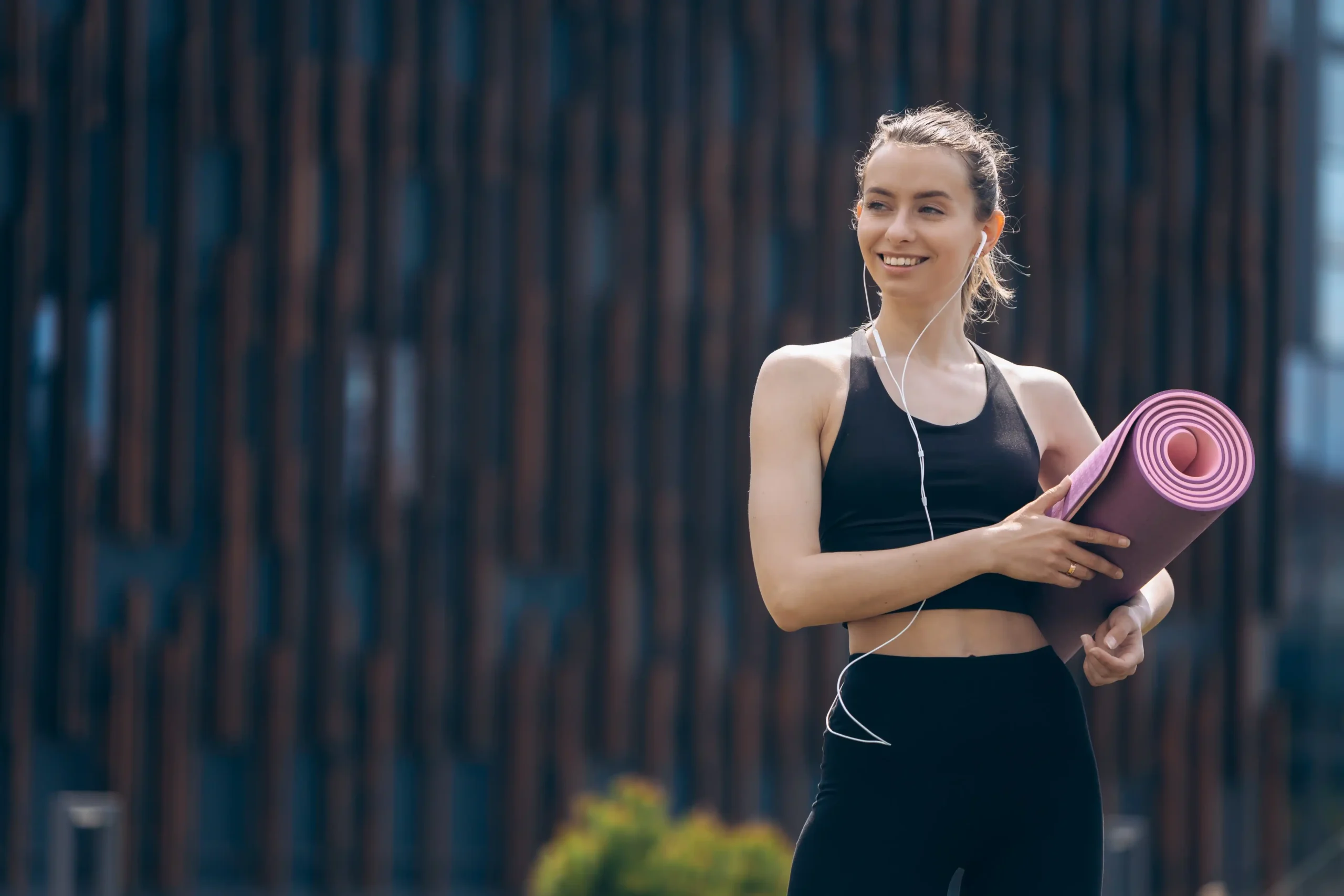 blonde girl with ponytail holding rolled pink yoga mat 11zon blonde girl with ponytail holding rolled pink yoga mat 11zon