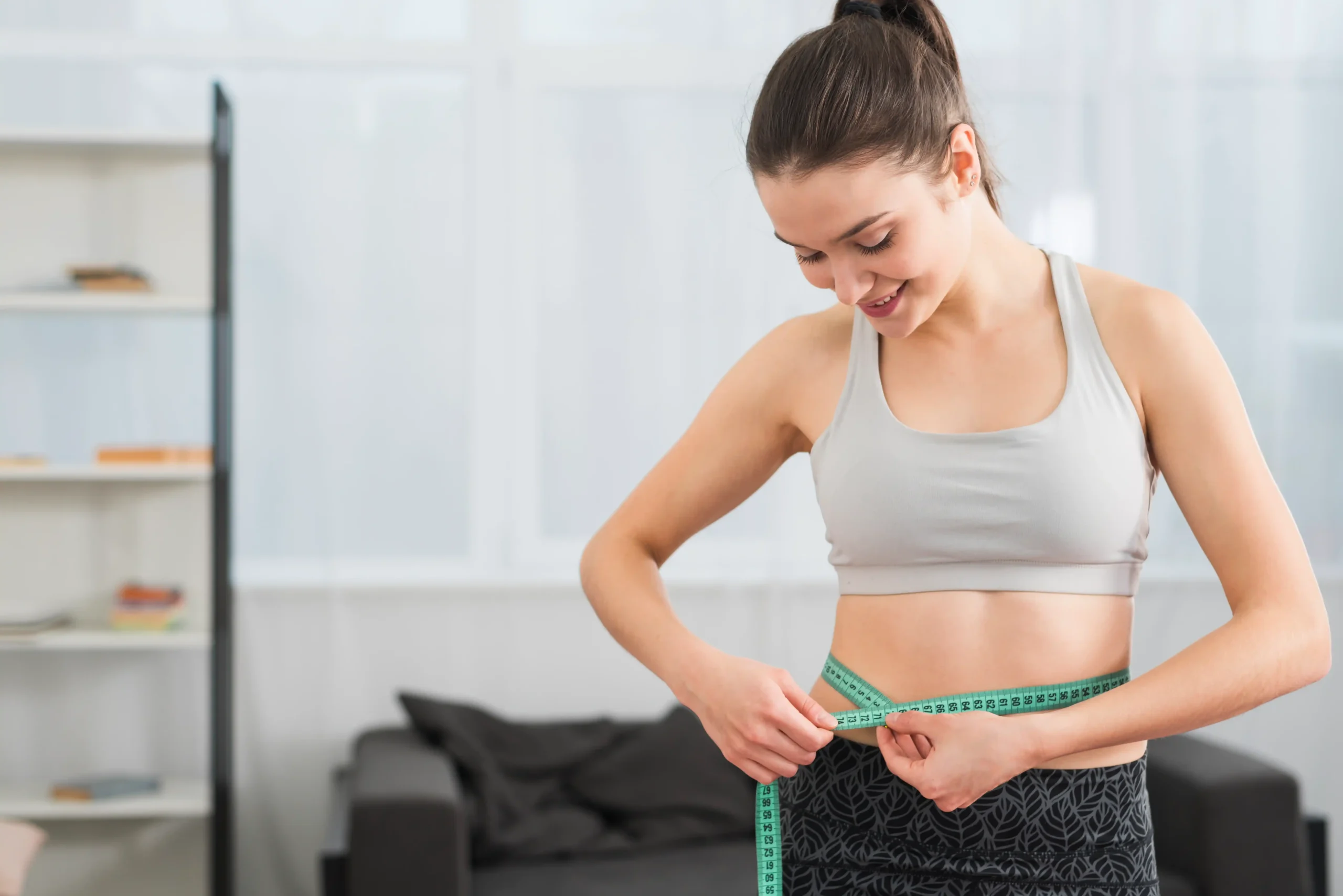 fitness girl measuring herself (1) 11zon fitness girl measuring herself (1) 11zon