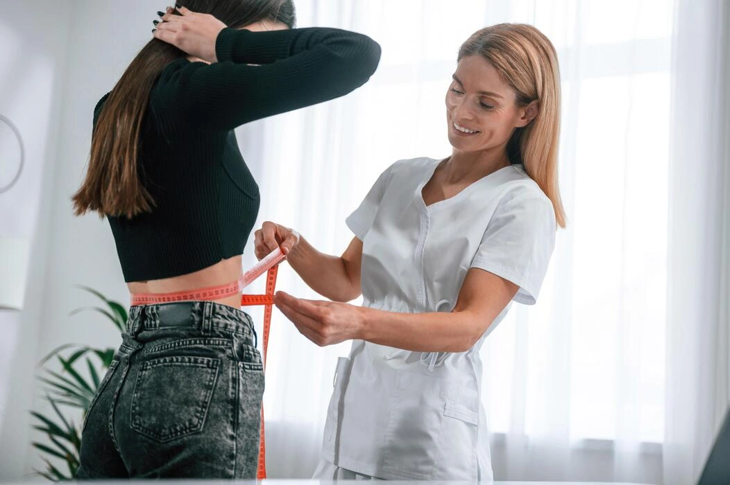 measuring the waist young woman at a nutritionist s appointment medical care photo measuring the waist young woman at a nutritionist s appointment medical care photo